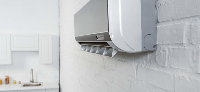 close-up-shot-of-air-conditioner-hanging-on-white--ZEZDHLM